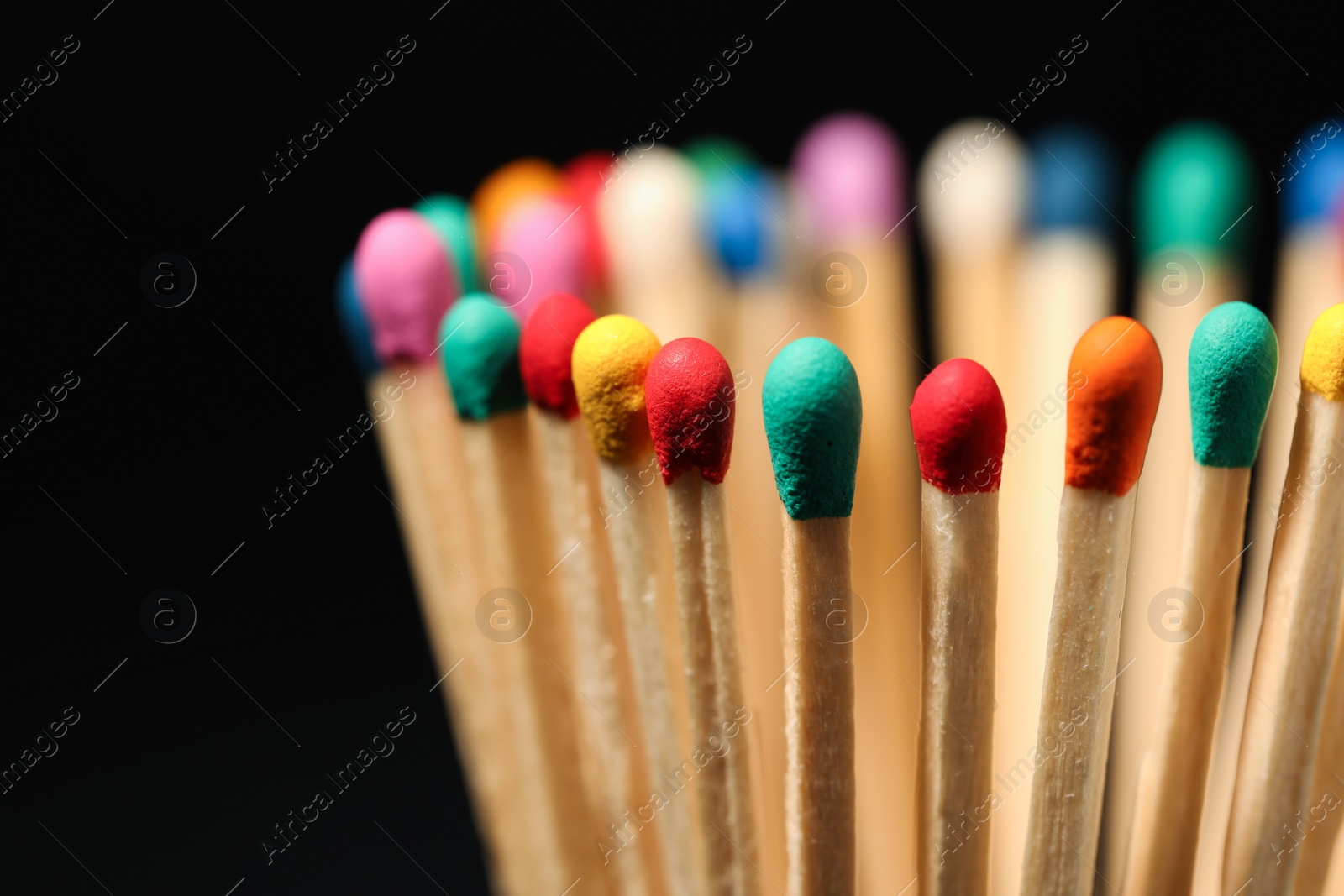 Photo of Matches with colorful heads on black background, closeup