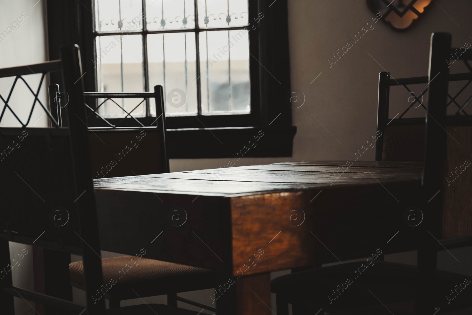 Photo of Wooden table and chairs in cafe. Interior design