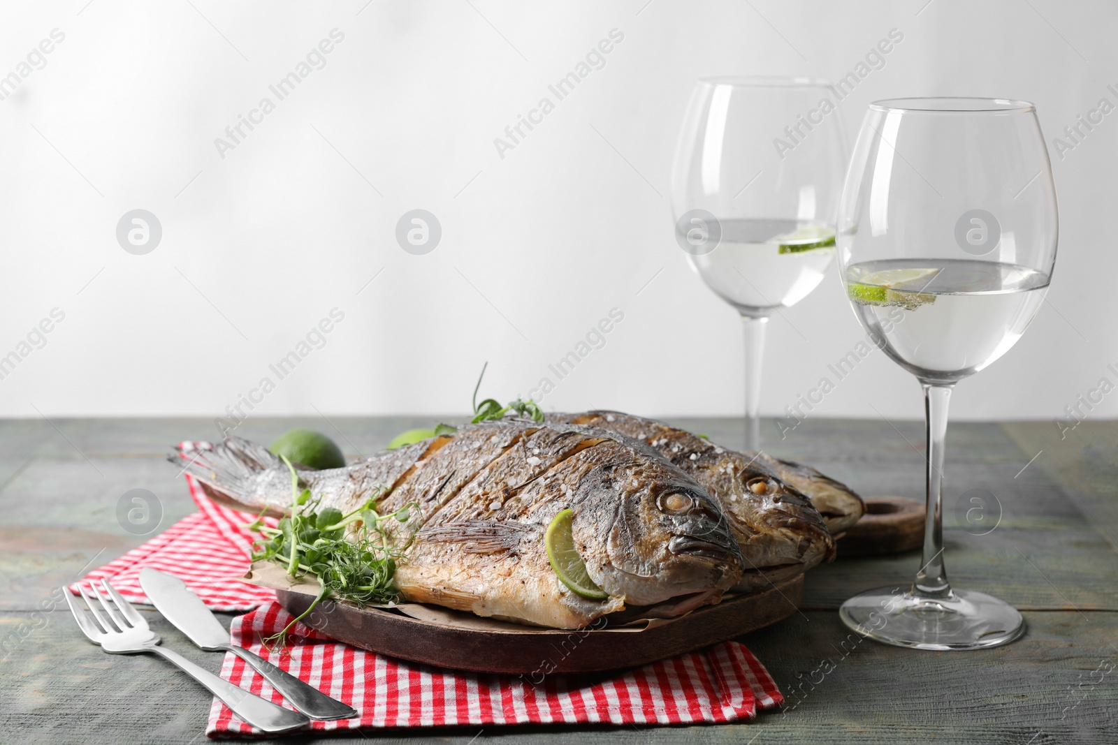 Photo of Seafood. Delicious baked fish served on rustic wooden table, space for text