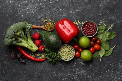 Photo of Different vegetables on grey textured table, flat lay. Vegan diet