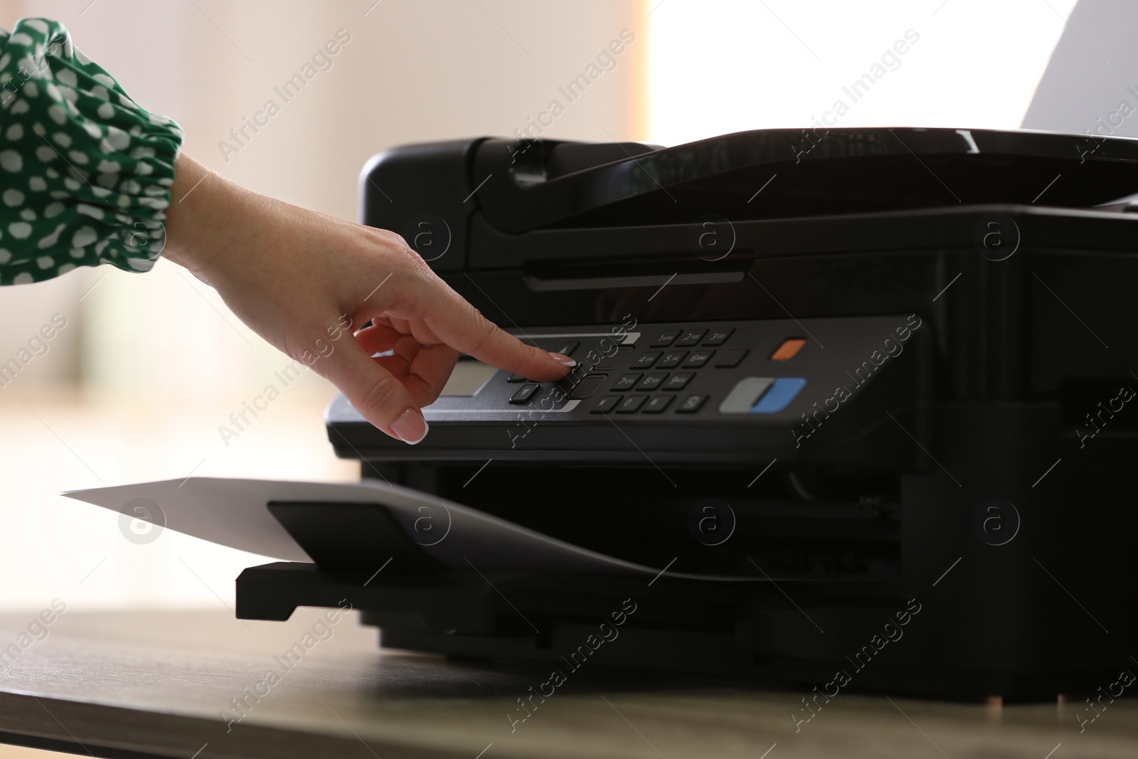 Photo of Woman using modern printer in office, closeup