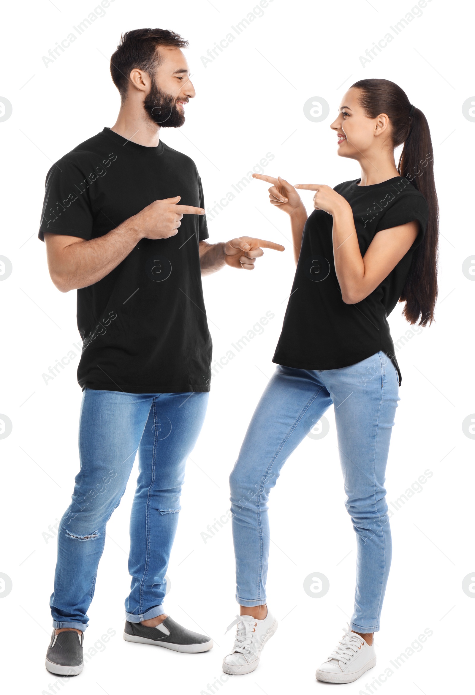 Photo of Young couple in t-shirts on white background. Mockup for design