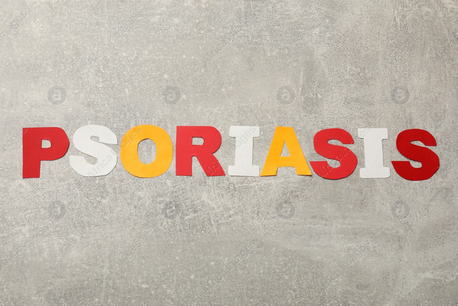 Photo of Word Psoriasis made of paper letters on light gray textured table, top view