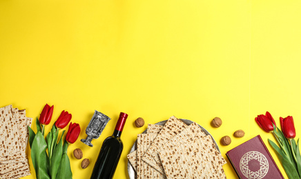 Photo of Flat lay composition with matzos on yellow background, space for text. Passover (Pesach) celebration