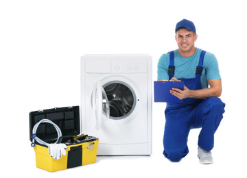 Repairman with clipboard and toolbox near washing machine on white background