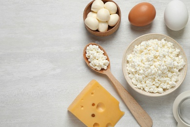 Photo of Different dairy products on white table, flat lay. Space for text