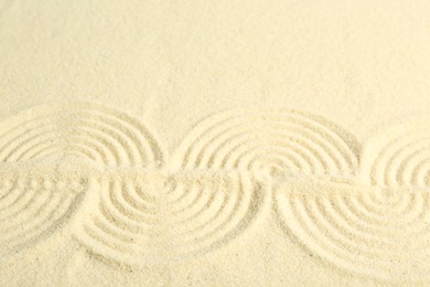 Zen rock garden. Wave pattern on beige sand