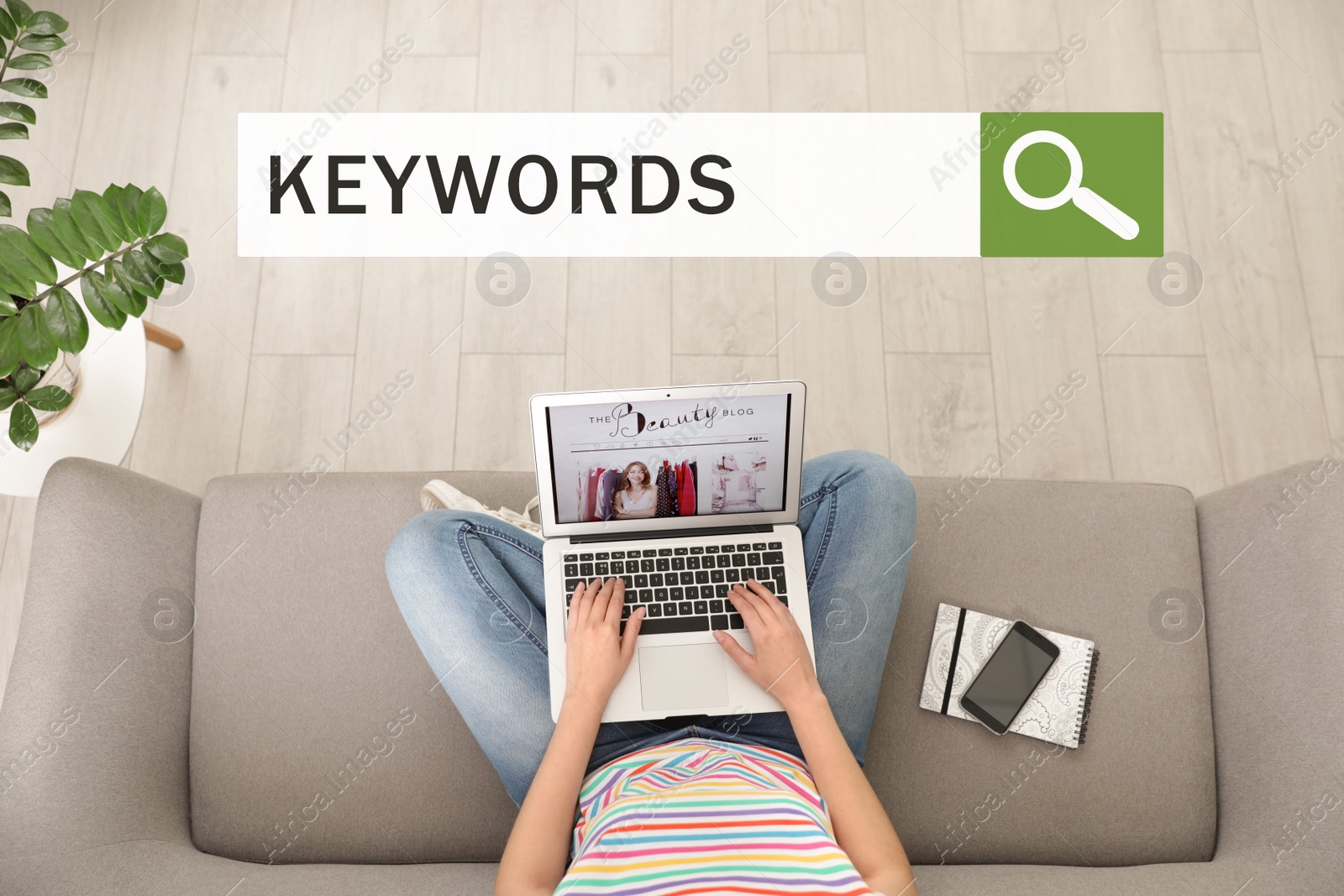 Image of Search bar with text KEYWORDS and woman with laptop on sofa, top view