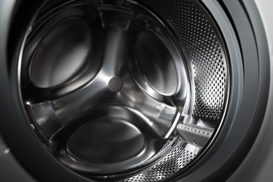 Photo of Empty washing machine drum, closeup. Laundry day
