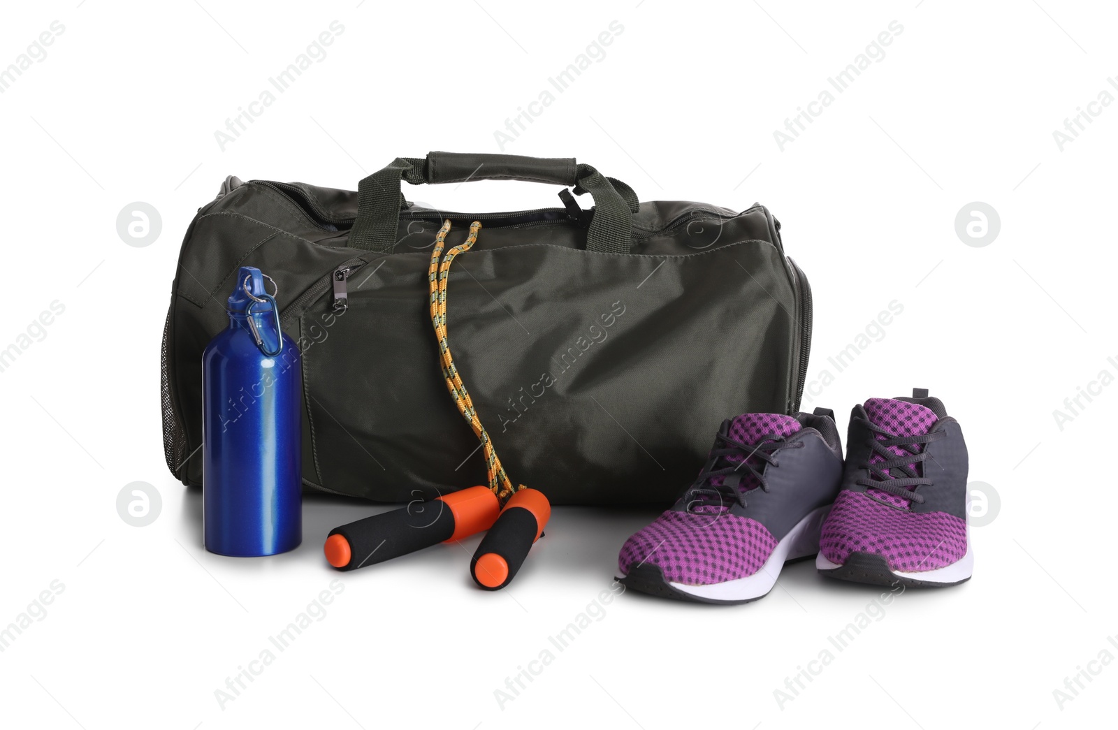 Photo of Sports bag and gym equipment on white background