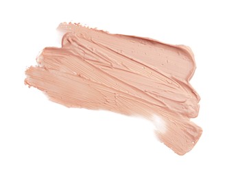 Photo of Strokes of pink color correcting concealer isolated on white, top view