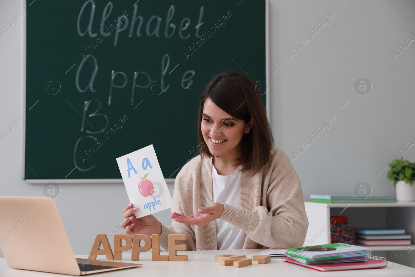 Photo of Happy English teacher giving online lesson. Early childhood education