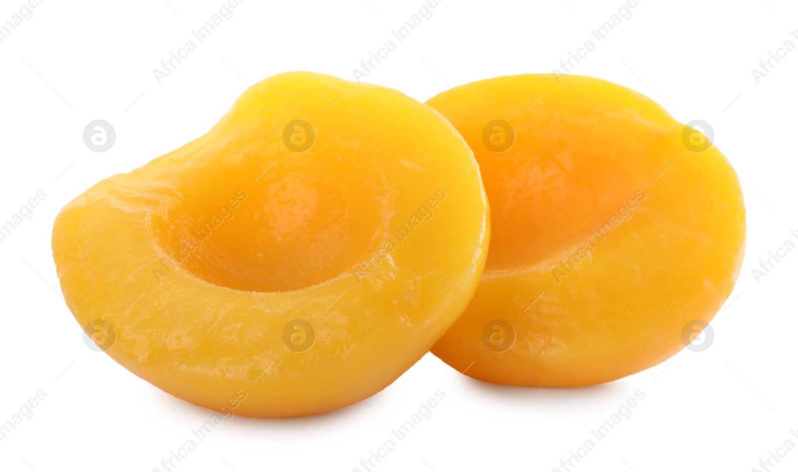 Photo of Sweet juicy canned peach halves isolated on white