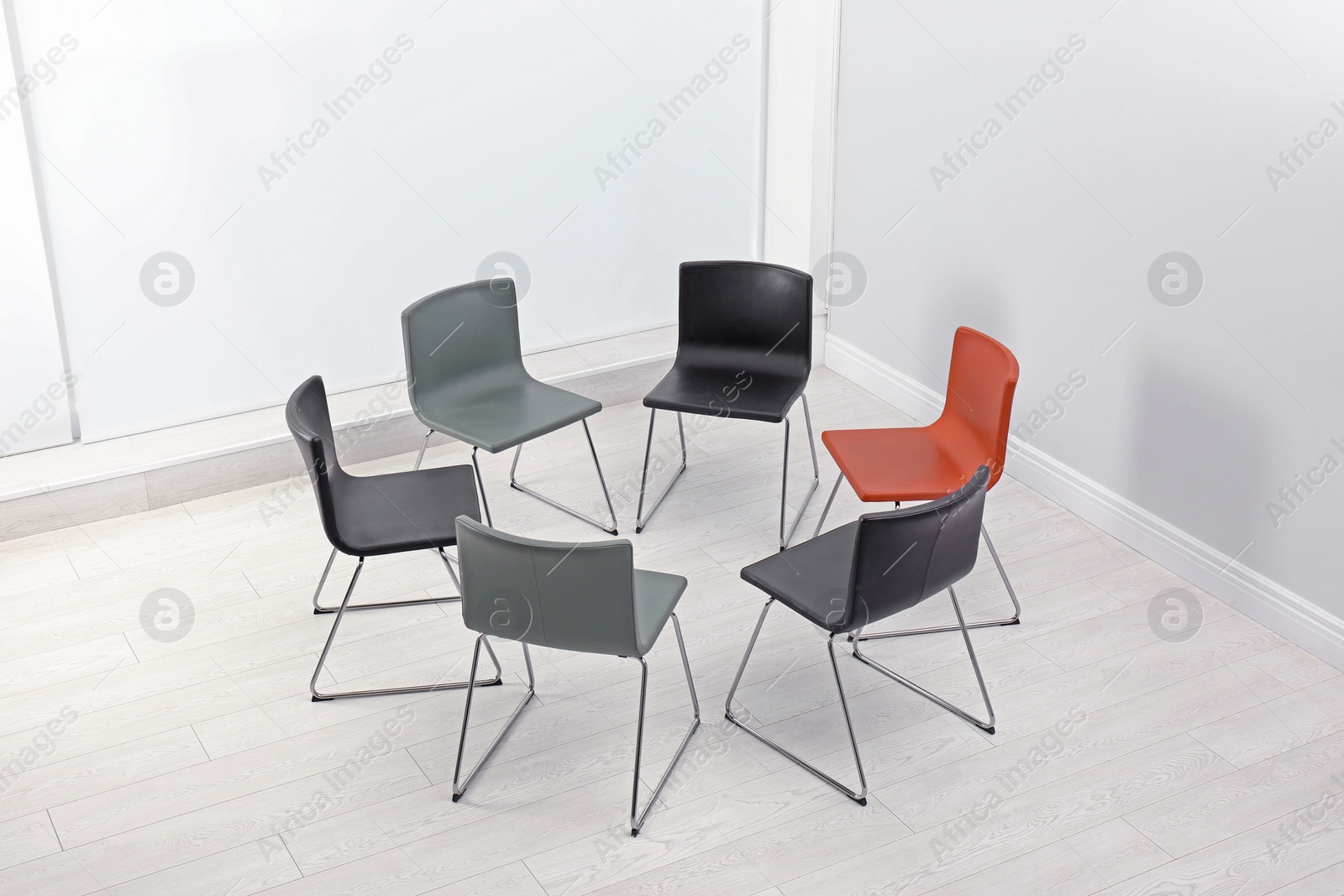 Photo of Chairs prepared for group therapy session in office. Meeting room interior