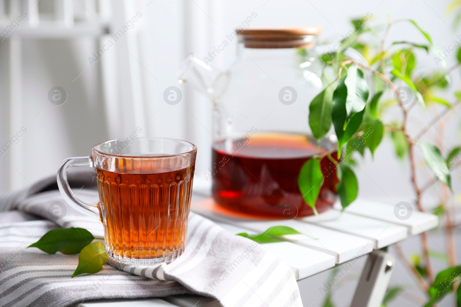 Photo of Tasty warm tea in cup on table, closeup