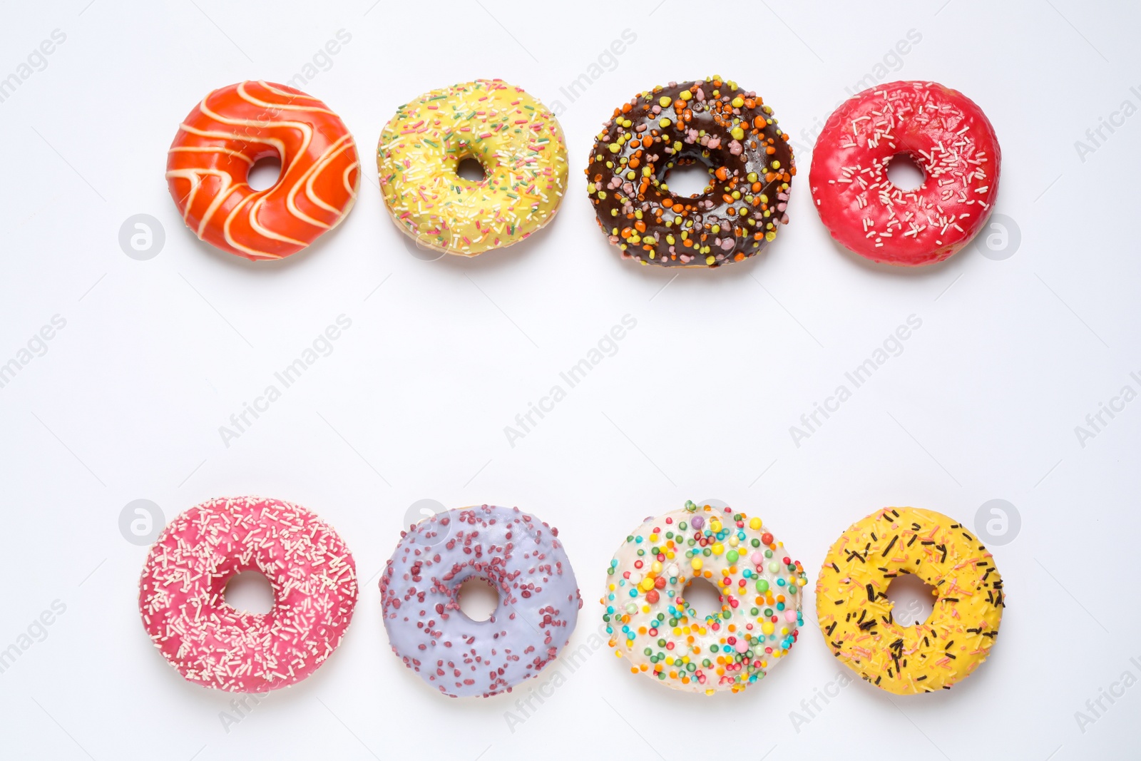 Photo of Delicious glazed donuts on white background, flat lay. Space for text