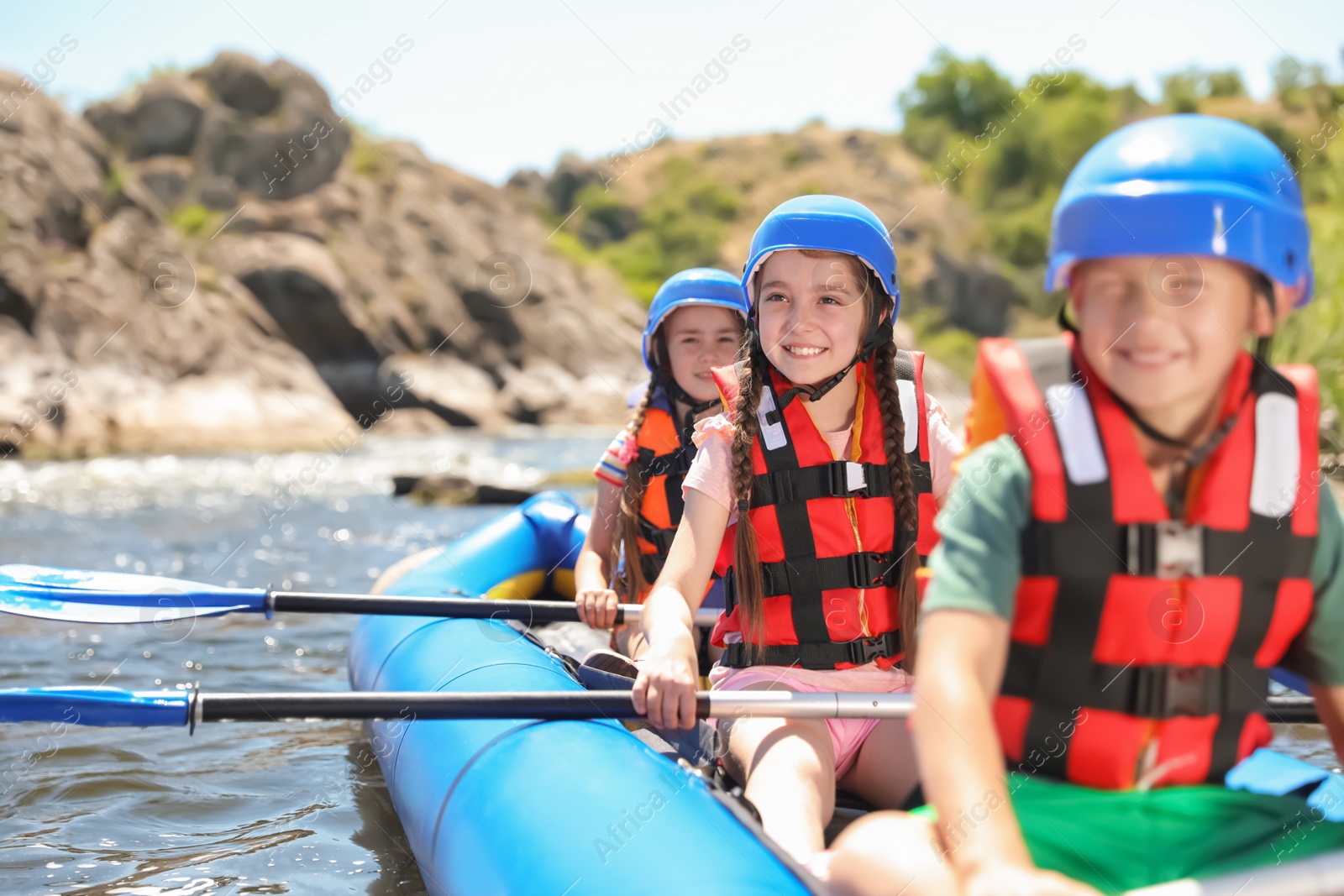 Photo of Little children kayaking on river. Summer camp