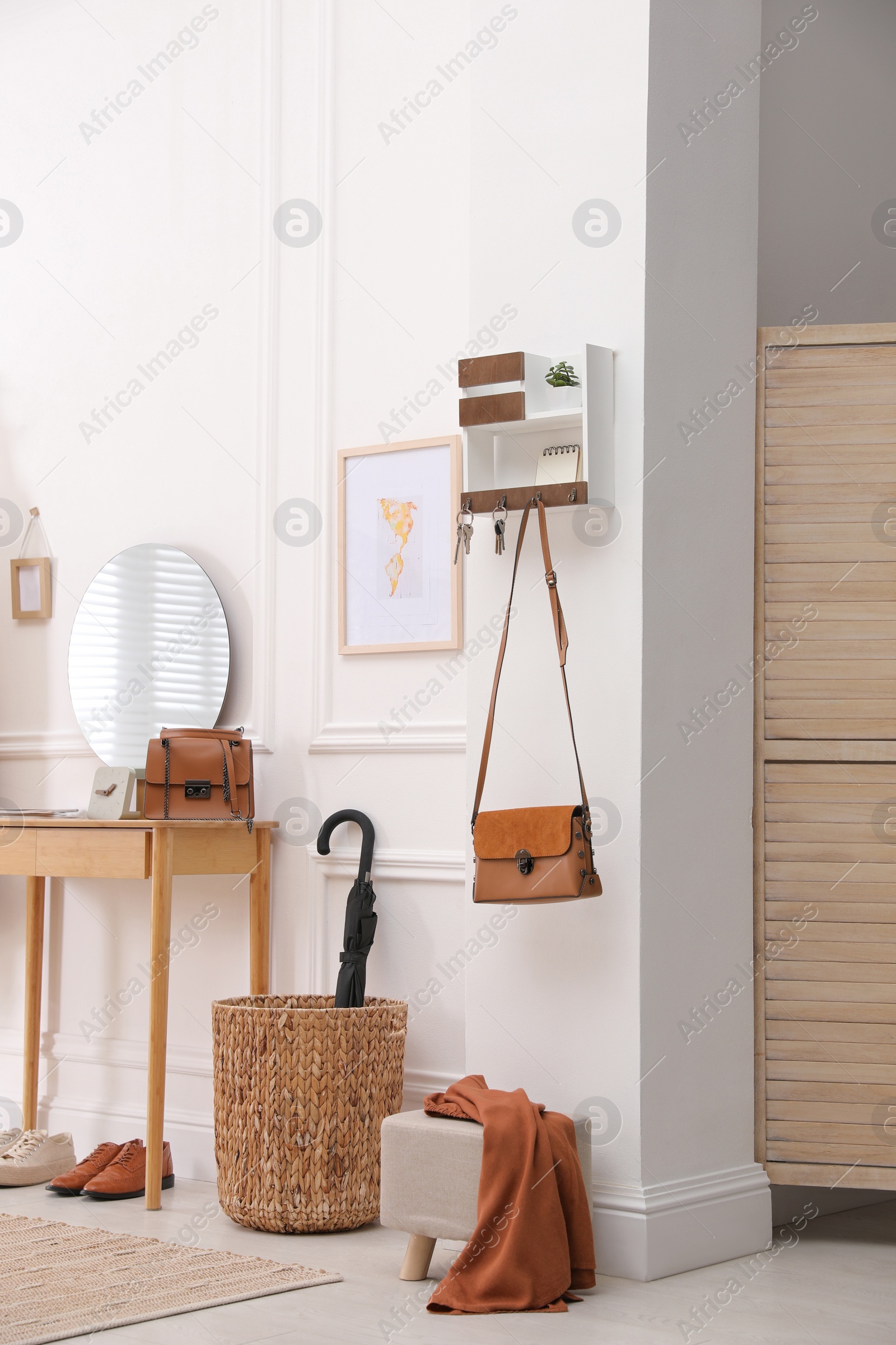 Photo of Modern hallway interior with stylish dressing table and key holder