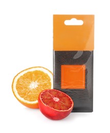 Scented sachet and halves of different oranges on white background