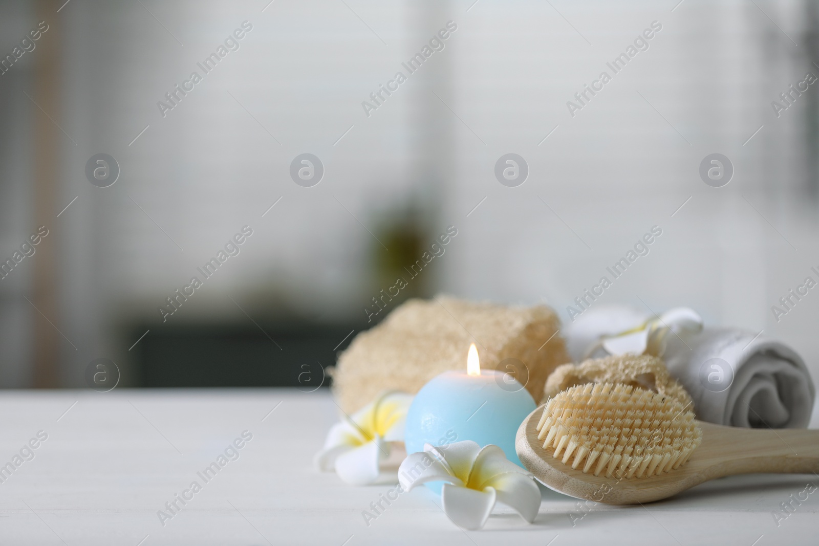 Photo of Composition with different spa supplies and flowers on white wooden table indoors, space for text