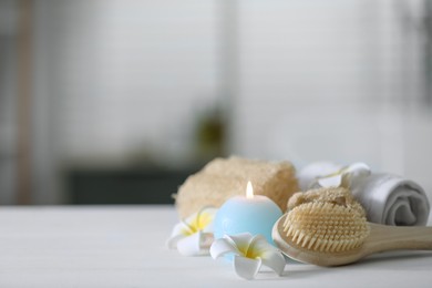 Photo of Composition with different spa supplies and flowers on white wooden table indoors, space for text