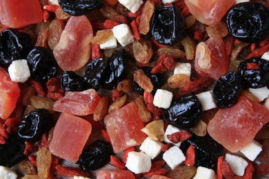 Different tasty dried fruits on wooden table, flat lay