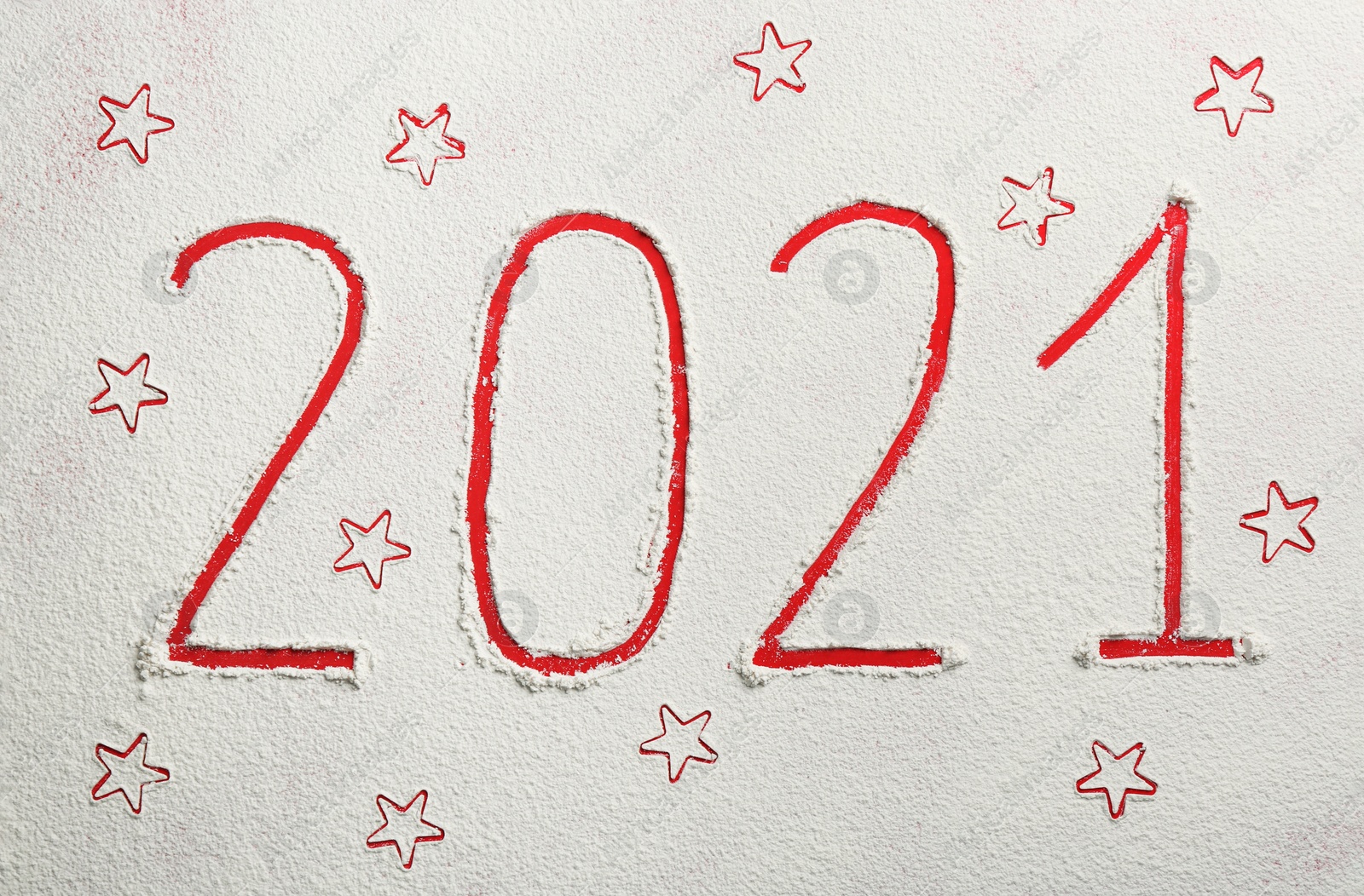 Photo of 2021 and stars made of flour on red background, top view