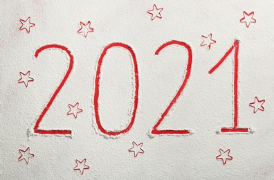 Photo of 2021 and stars made of flour on red background, top view