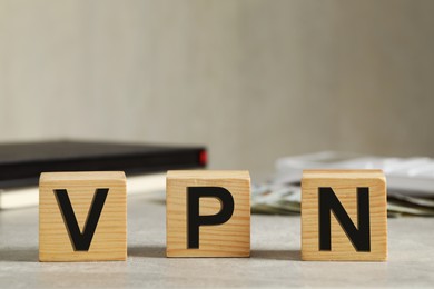 Wooden cubes with acronym VPN on grey stone table