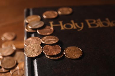 Photo of Donate and give concept. Coins and Bible on table, closeup
