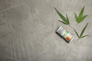 Photo of Flat lay composition with money and hemp leaves on gray background. Space for text