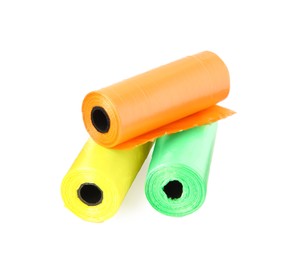 Photo of Colorful dog waste bags on white background