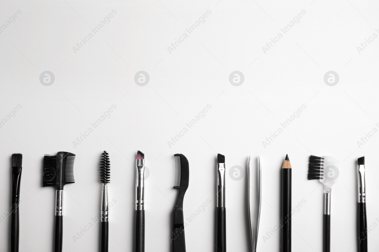 Photo of Set of professional eyebrow tools on white background, flat lay. Space for text