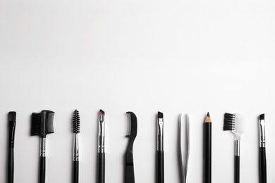 Photo of Set of professional eyebrow tools on white background, flat lay. Space for text