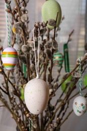 Beautiful willow branches with painted eggs indoors. Easter decor