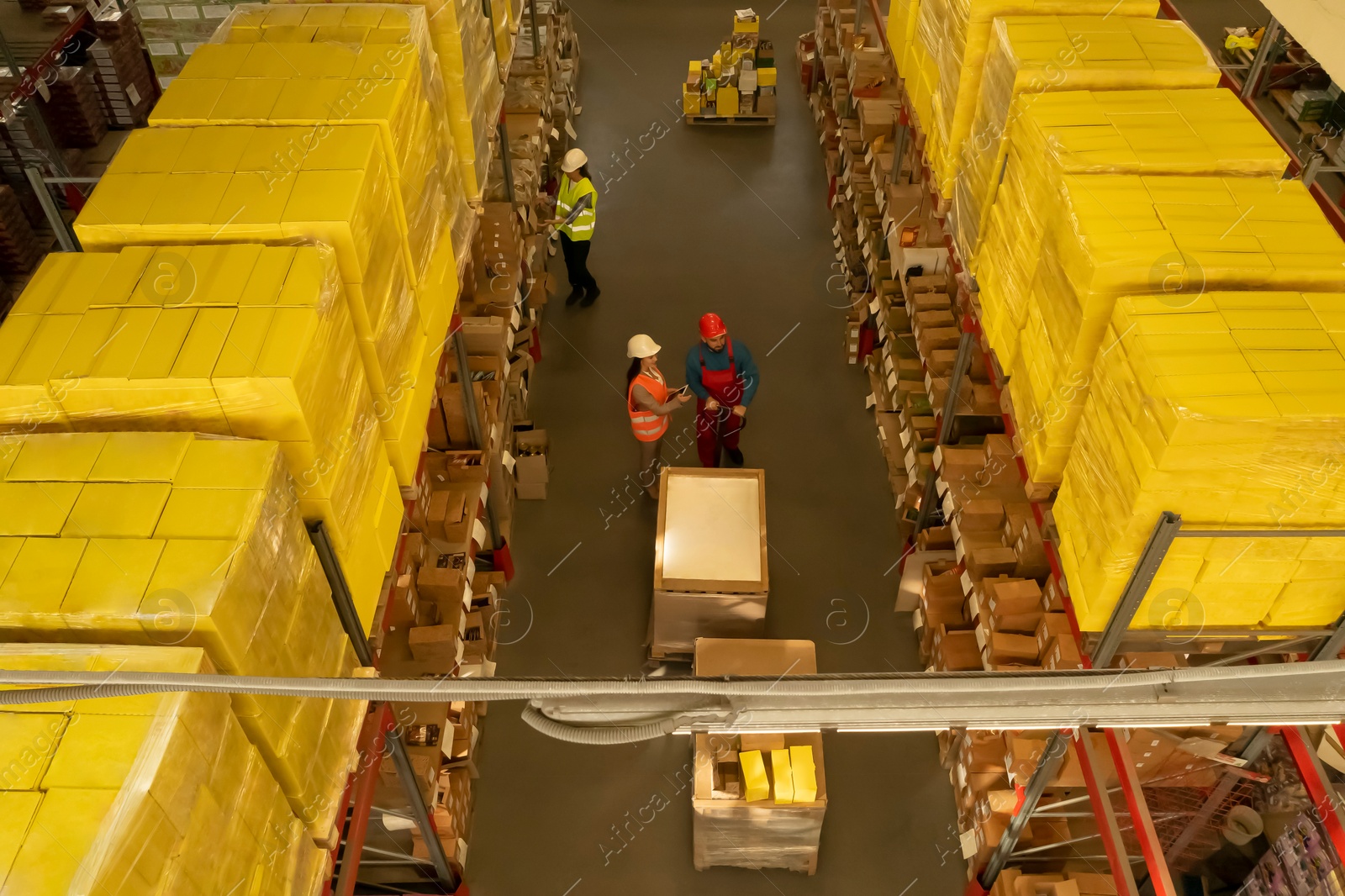 Image of Manager and workers at warehouse, above view. Logistics center