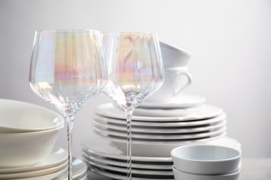 Set of clean dishes and glasses on table