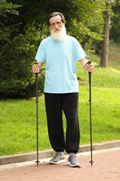 Senior man with Nordic walking poles outdoors