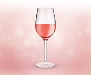 Image of Glass of expensive rose wine on light pink background