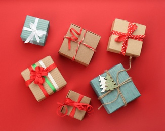 Christmas gift boxes on red background, flat lay