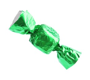 Tasty candy in green wrapper isolated on white