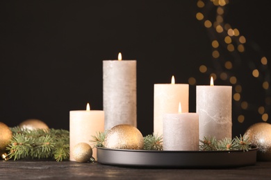 Photo of Burning candles with Christmas decoration on table. Space for text