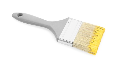 Photo of Brush with yellow paint isolated on white