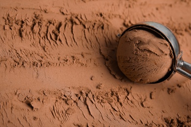 Photo of Scoop with ball on chocolate ice cream, closeup. Space for text