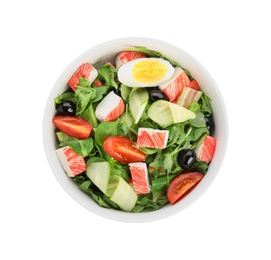 Photo of Delicious crab stick salad in bowl isolated on white, top view