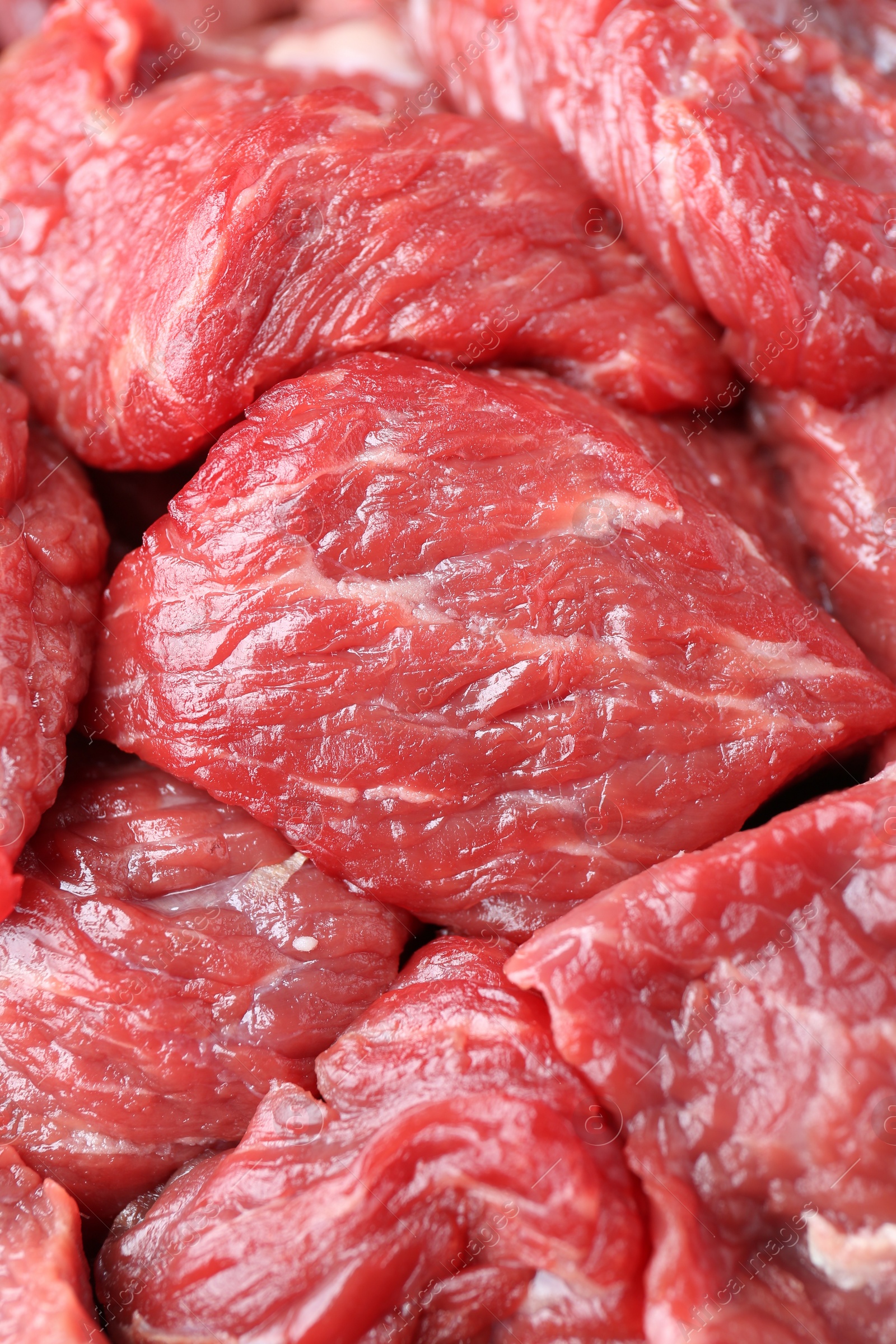 Photo of Pieces of raw beef meat as background, closeup