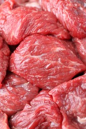 Pieces of raw beef meat as background, closeup