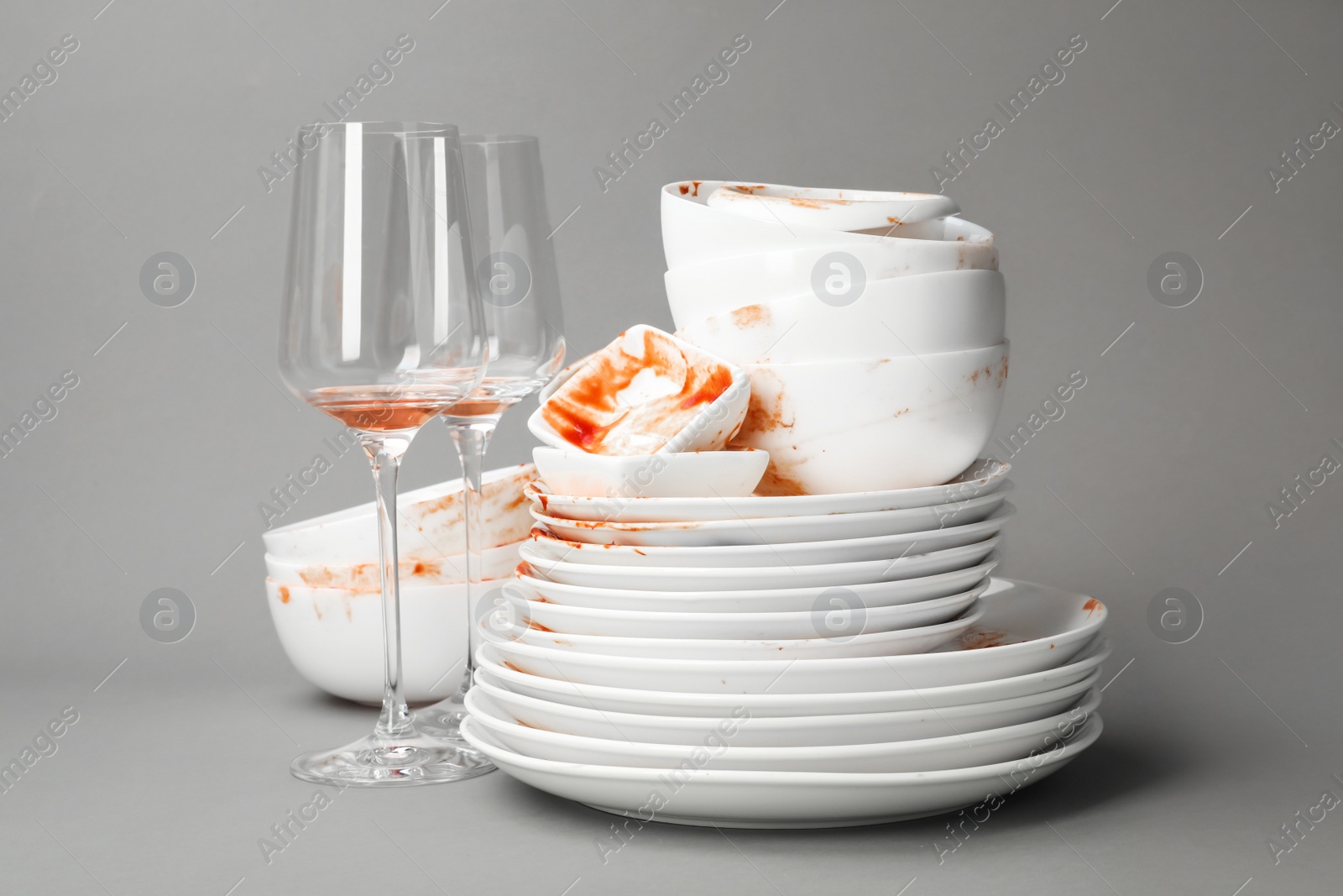 Photo of Set of dirty dishes on grey background