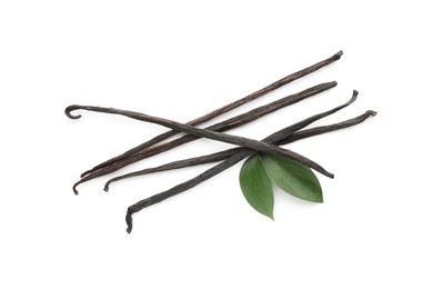 Photo of Aromatic vanilla pods and leaves isolated on white, top view