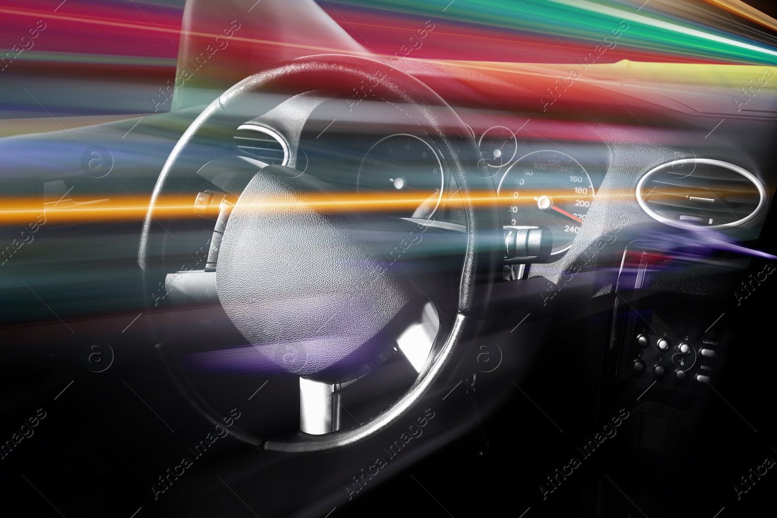 Image of Steering wheel and dashboard in car, motion blur. Speed movement effect